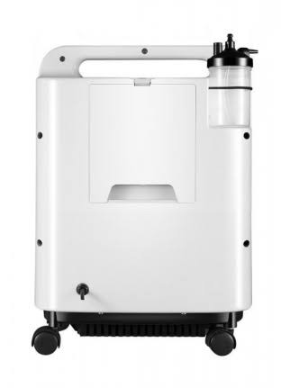 A white portable medical oxygen concentrator with a handle, wheels, and an attached clear gas tank on a plain white background.